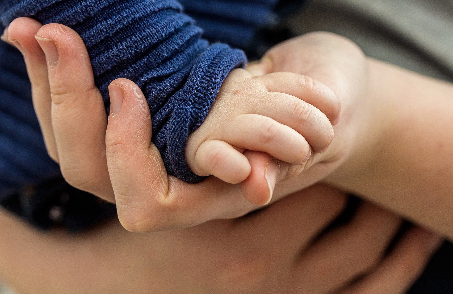 Family law solicitors - Mum holding baby's hand